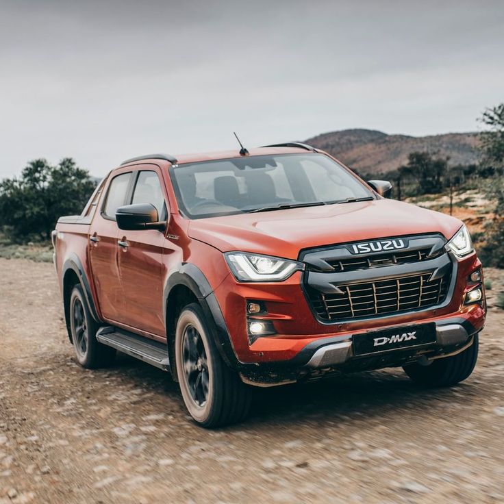 Blue 2019 Isuzu D-Max pickup truck parked on a rural Kenyan dirt road with hills in the background